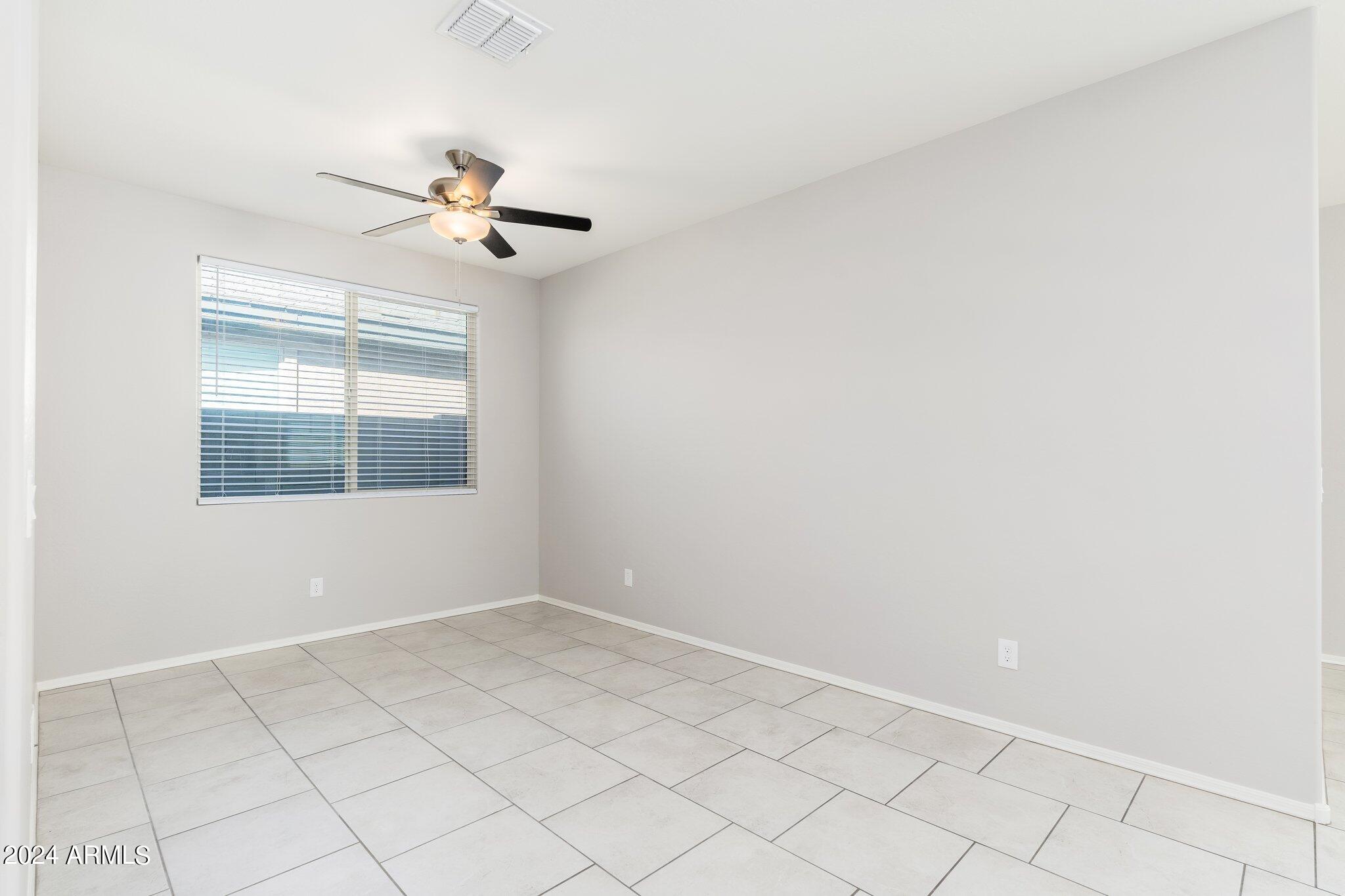 2764 West Apollo Road Phoenix, AZ 85041 - Photo 6 of 45 a view of an empty room with a window