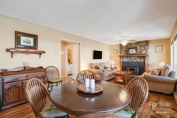 a living room with furniture a fireplace and a large window
