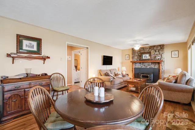 a living room with furniture a fireplace and a large window