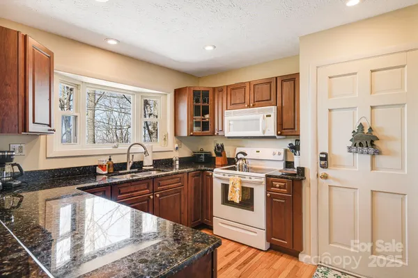 a kitchen with a stove sink and cabinets