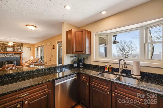 a kitchen with sink a window and cabinets