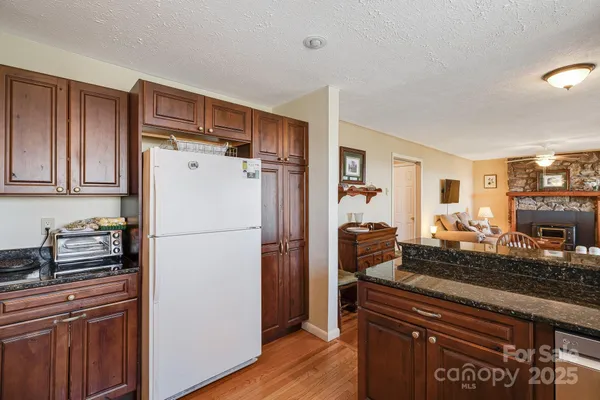 a kitchen with a refrigerator and a stove top oven