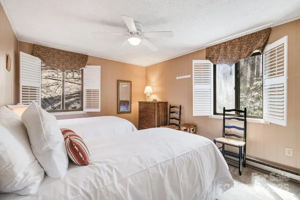 a bedroom with a bed and a large window