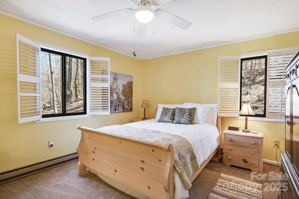 a bedroom with a bed and a large window