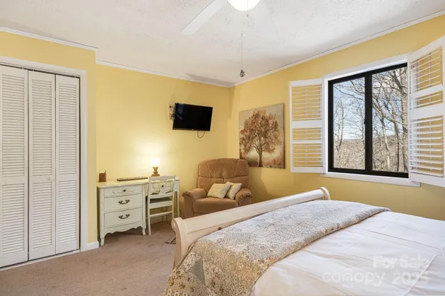 a bedroom with a bed and a flat screen tv