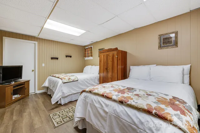 a bedroom with double bed and a flat screen tv