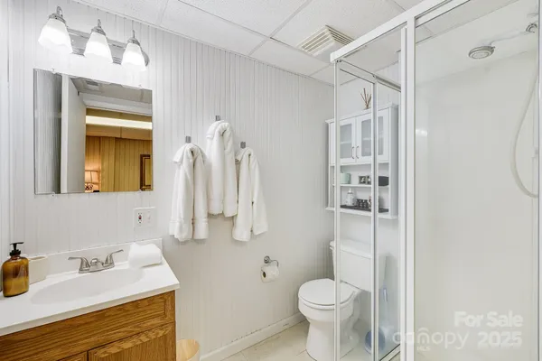 a bathroom with a sink toilet and shower