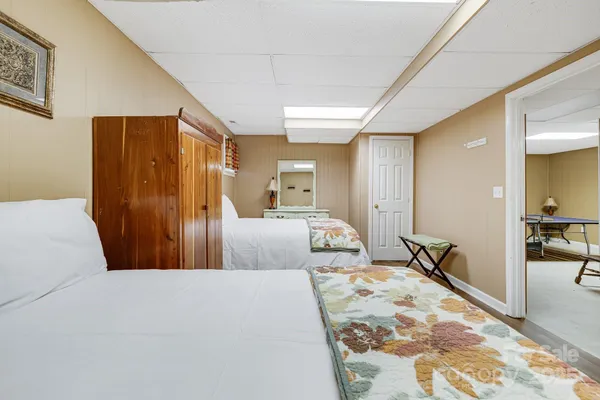 a bedroom with a large bed and dresser