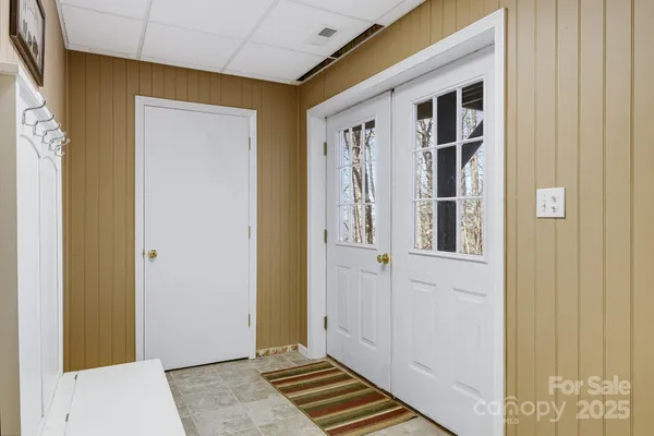 a view of a hallway with wooden floor and closet