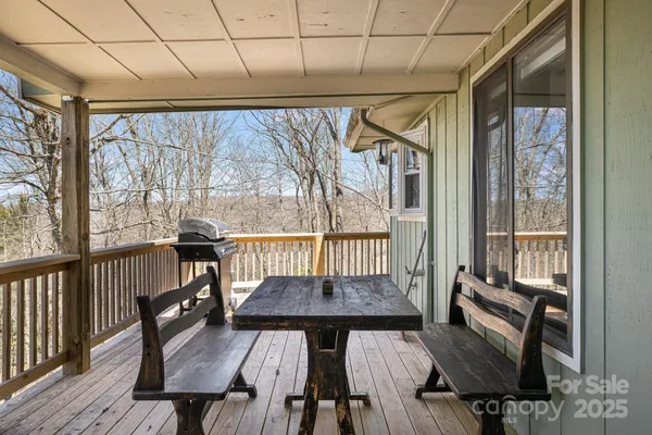 a view of a balcony with furniture and wooden floor
