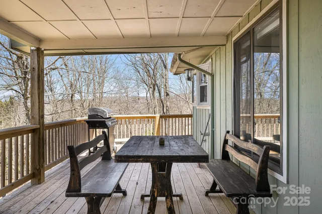 a view of a balcony with furniture and wooden floor