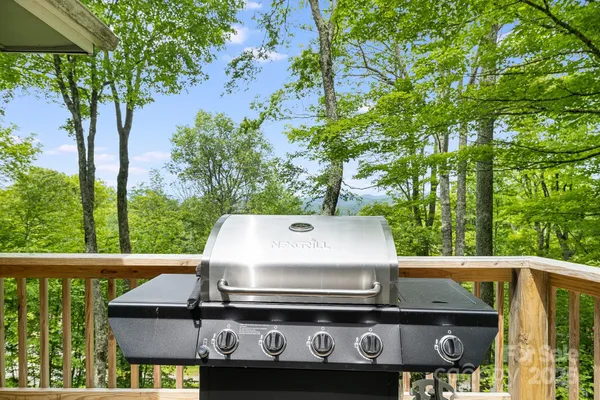a view of barbeque grill with granite counter top and outdoor seating