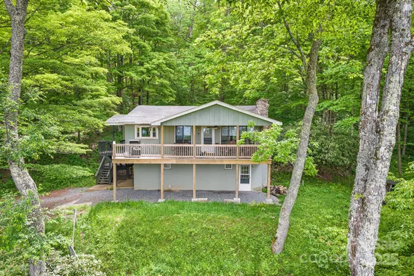 a front view of a house with a yard and balcony