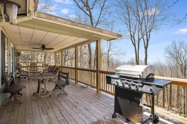 a view of a patio with table and chairs with wooden floor and fence