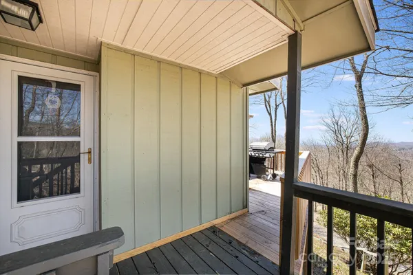 a view of a hallway with wooden floor and stairs