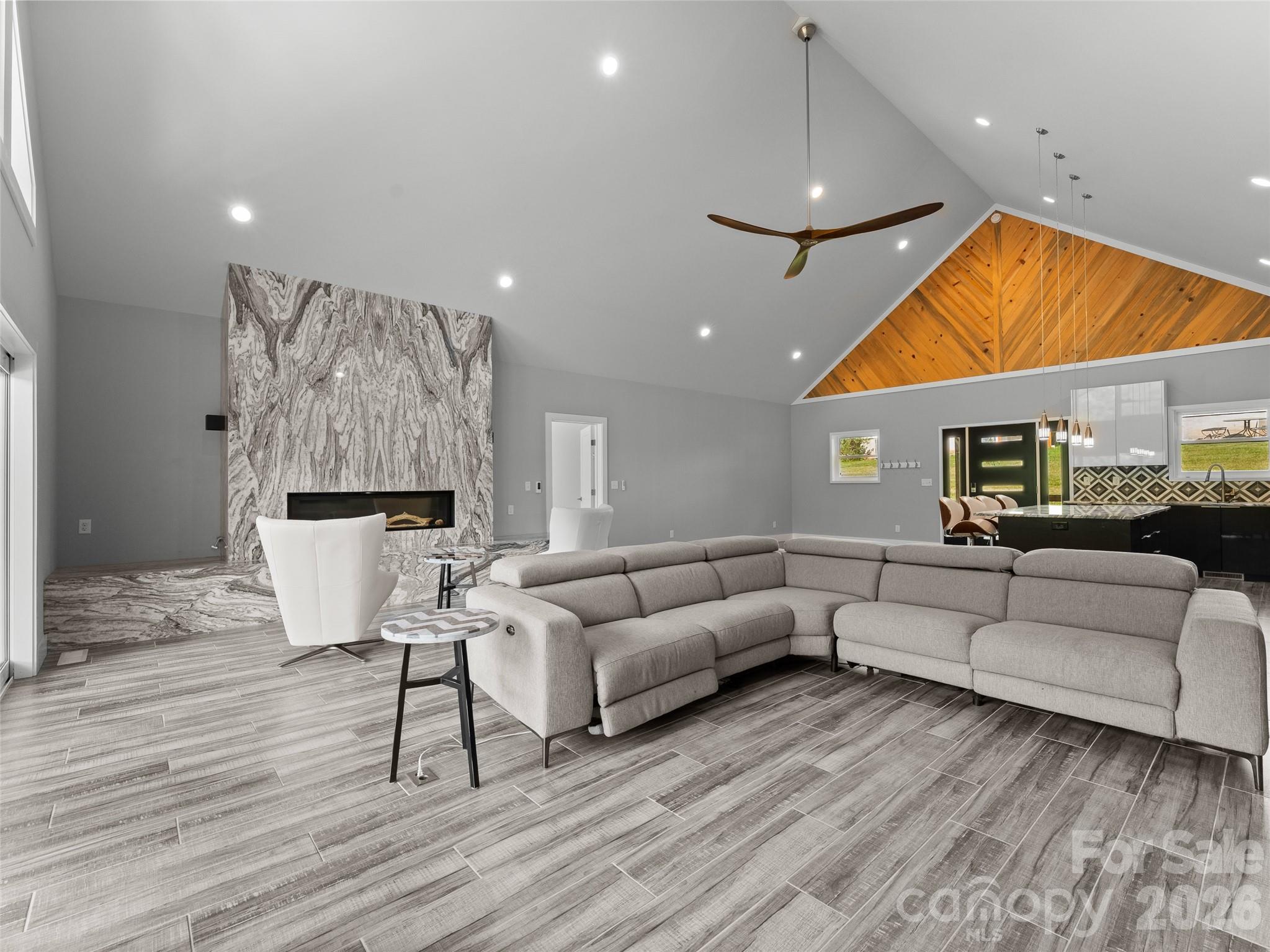 123 Israel Road Candler, NC 28715 - Photo 14 of 44 a living room with furniture ceiling fan and a wooden floor