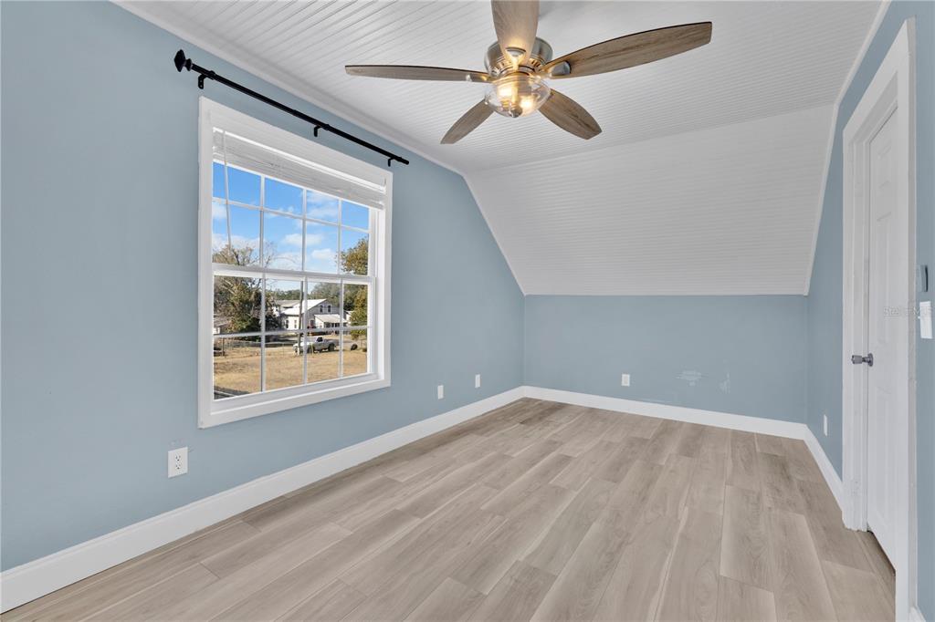 922 Delaware Avenue St. Cloud, FL 34769 - Photo 12 of 22 wooden floor in an empty room with a window