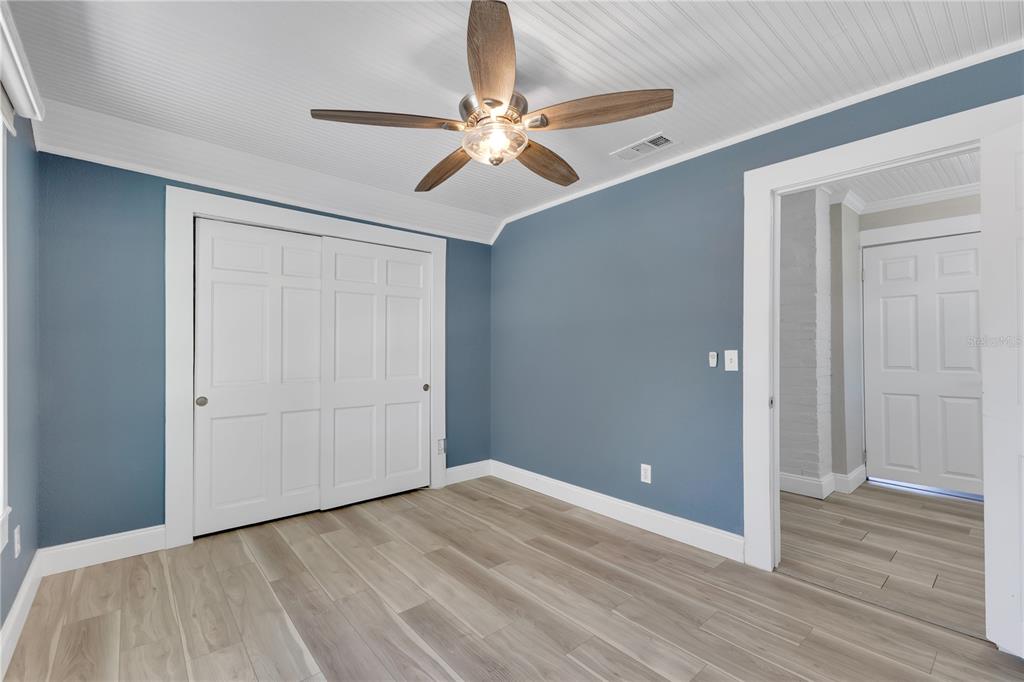 922 Delaware Avenue St. Cloud, FL 34769 - Photo 15 of 22 a view of a room with wooden floor and white walls
