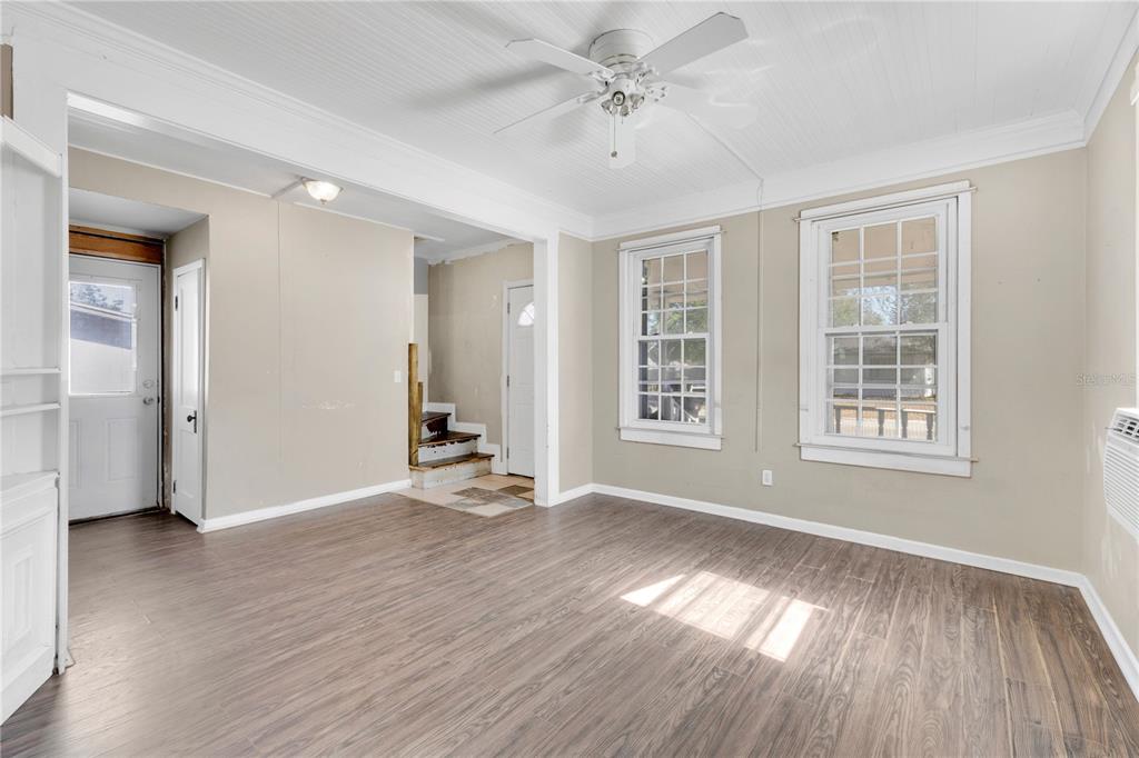 922 Delaware Avenue St. Cloud, FL 34769 - Photo 3 of 22 an empty room with wooden floor and windows