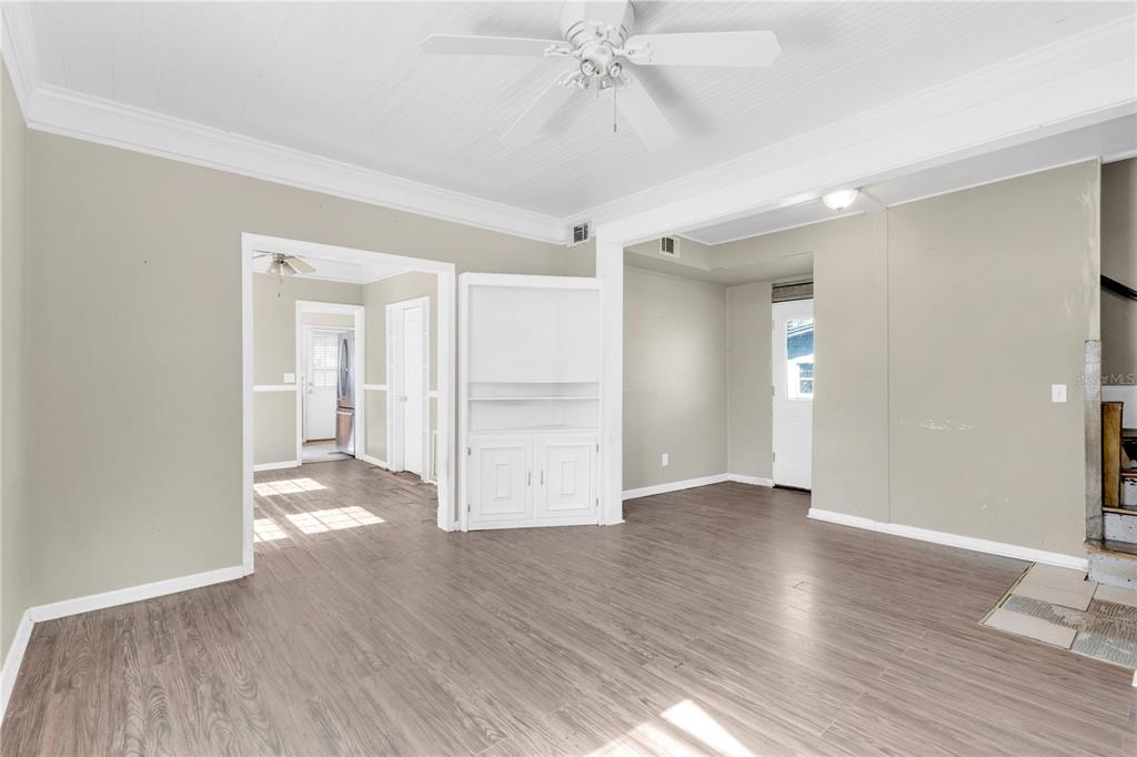 922 Delaware Avenue St. Cloud, FL 34769 - Photo 4 of 22 a view of an empty room with wooden floor