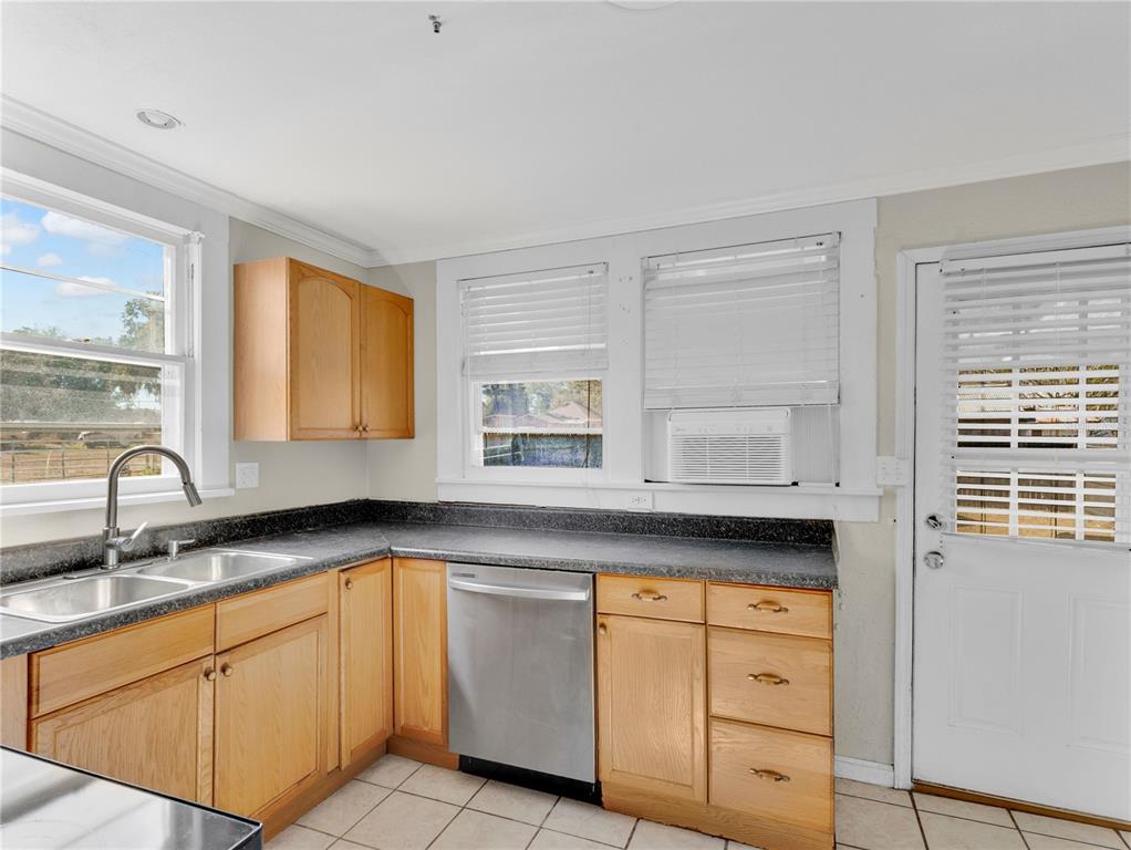 922 Delaware Avenue St. Cloud, FL 34769 - Photo 8 of 22 a kitchen with granite countertop white cabinets and sink