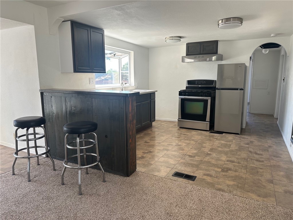 3549 Esplanade, Unit 402 Chico, CA 95973 - Photo 2 of 11 a kitchen with furniture a refrigerator and a sink