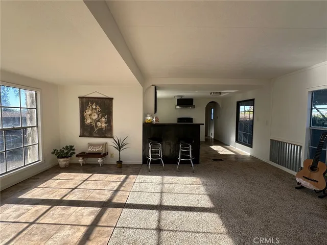 a living room with furniture a dining table and a fireplace