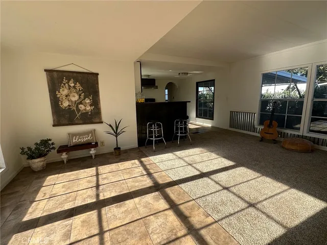 a living room with furniture a dining table and chairs with wooden floor