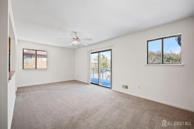 an empty room with windows and closet