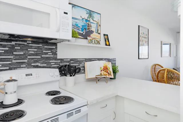 a kitchen with a sink a stove and cabinets
