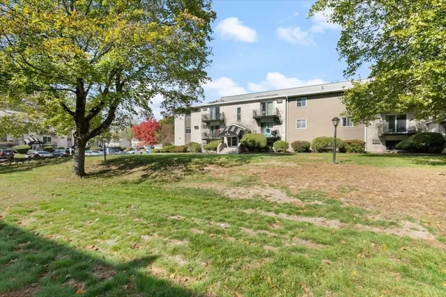 a vase of flowers sitting on a table in a sidewalk