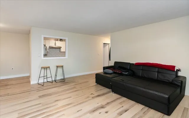 a living room with a couch and a wooden floor