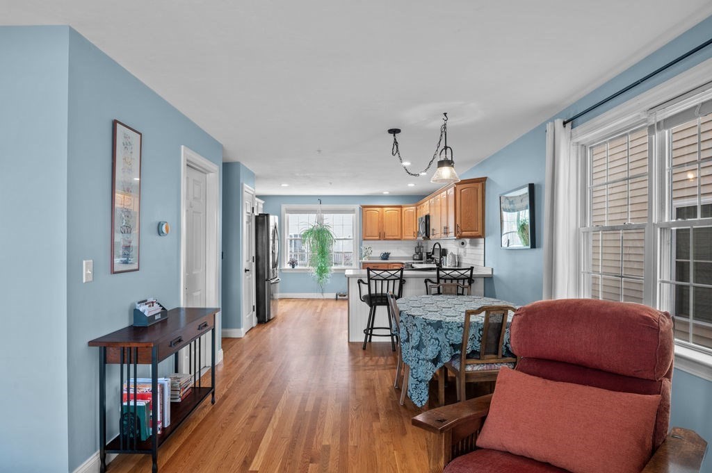 28 West Street, Unit 4A Ayer, MA 01432 - Photo 12 of 37 a living room with furniture and a wooden floor
