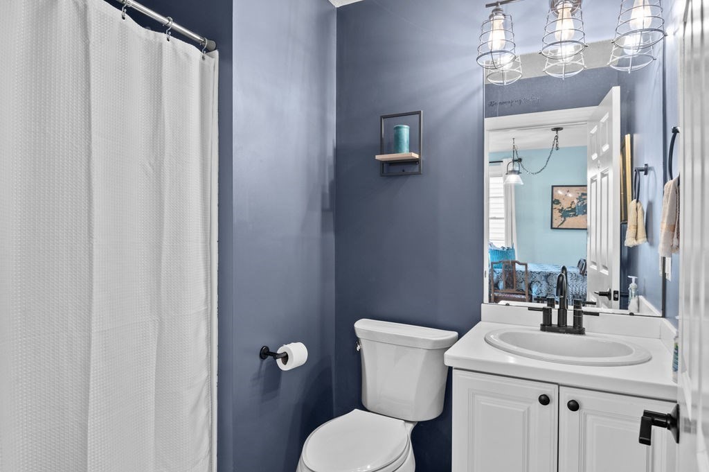 28 West Street, Unit 4A Ayer, MA 01432 - Photo 13 of 37 a bathroom with a toilet a sink and mirror