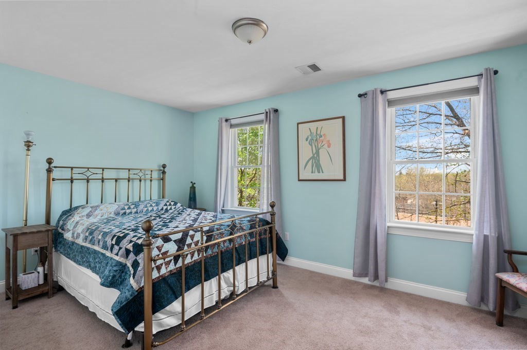 28 West Street, Unit 4A Ayer, MA 01432 - Photo 14 of 37 a bed sitting in a bedroom next to a window