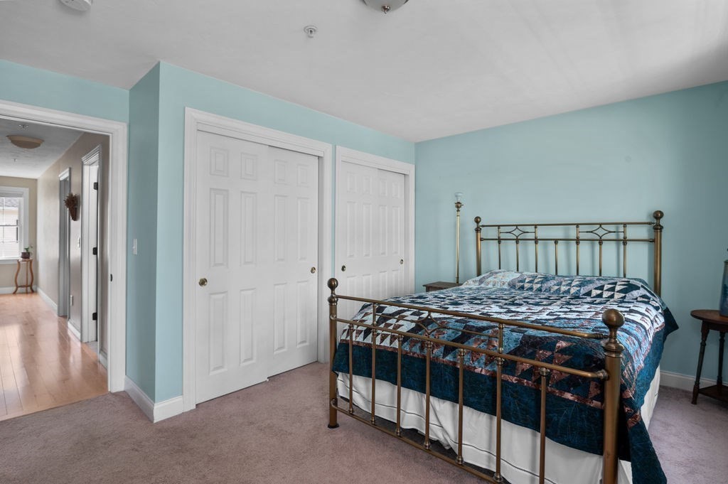 28 West Street, Unit 4A Ayer, MA 01432 - Photo 15 of 37 a bedroom with a bed and a table