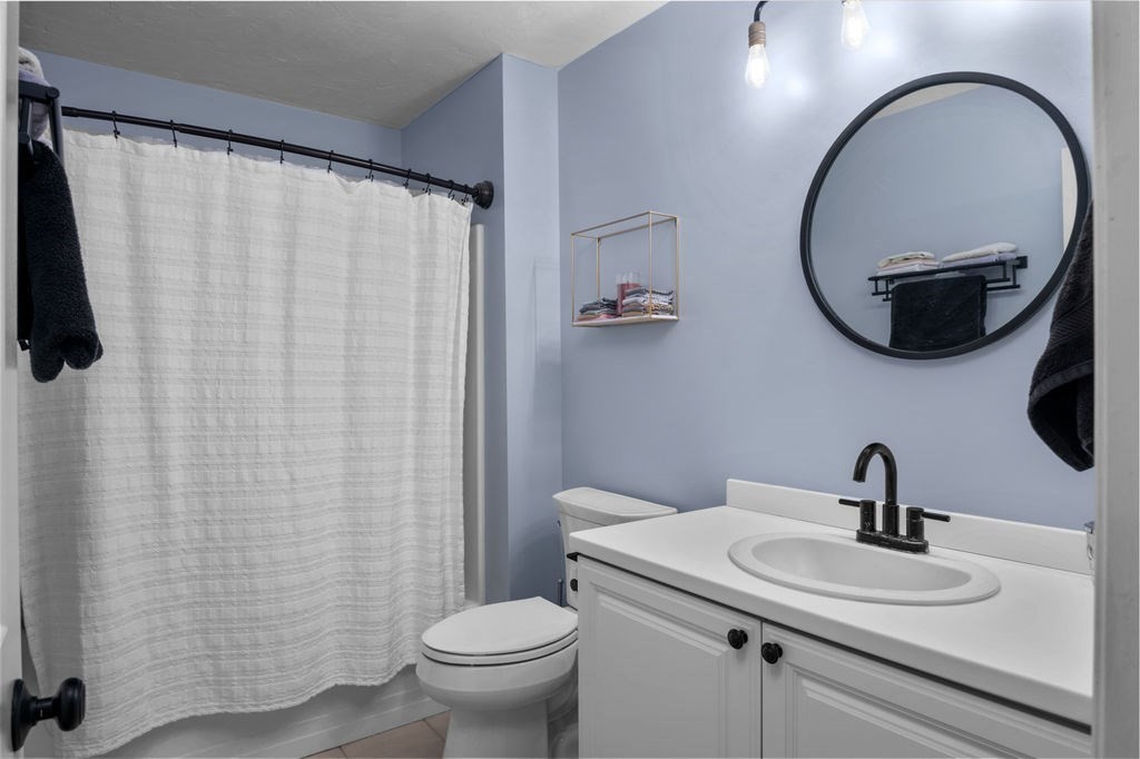 28 West Street, Unit 4A Ayer, MA 01432 - Photo 22 of 37 a bathroom with a sink a mirror a toilet and a mirror