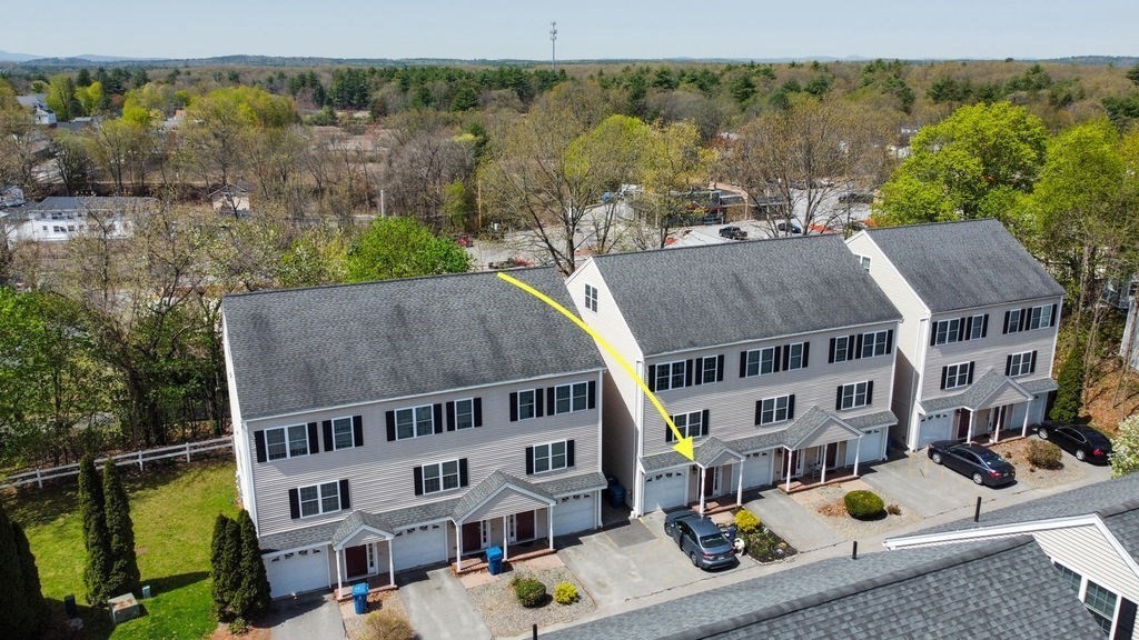 28 West Street, Unit 4A Ayer, MA 01432 - Photo 32 of 37 an aerial view of multiple houses with a yard