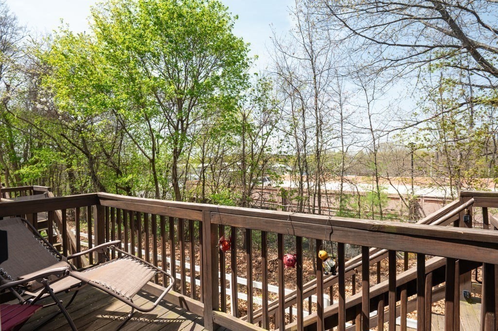 28 West Street, Unit 4A Ayer, MA 01432 - Photo 36 of 37 a view of a roof deck with wooden fence and trees
