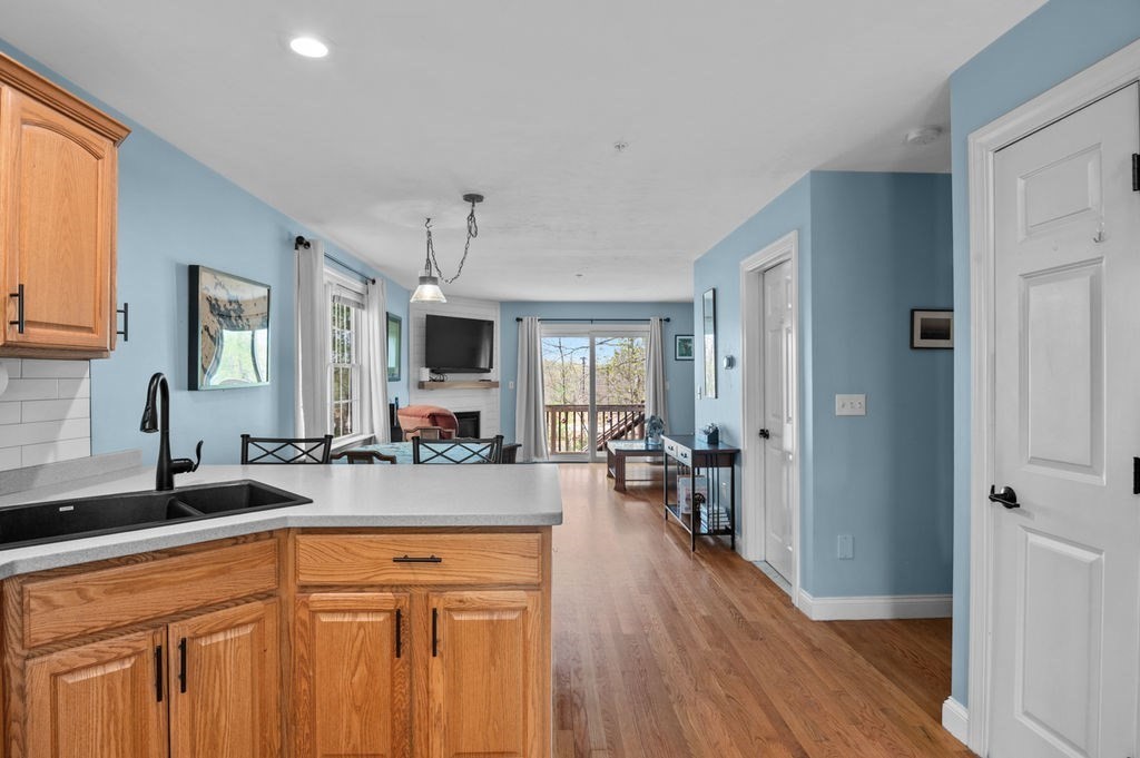 28 West Street, Unit 4A Ayer, MA 01432 - Photo 5 of 37 a large kitchen with lot of counter space and wooden floor
