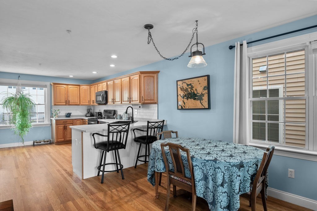 28 West Street, Unit 4A Ayer, MA 01432 - Photo 8 of 37 a view of a dining room with furniture window and wooden floor
