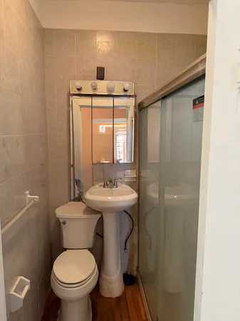 a bathroom with a toilet sink and mirror