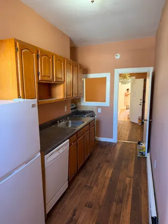 a kitchen with stainless steel appliances granite countertop a stove and a refrigerator