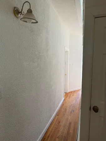a view of a room with wooden floor