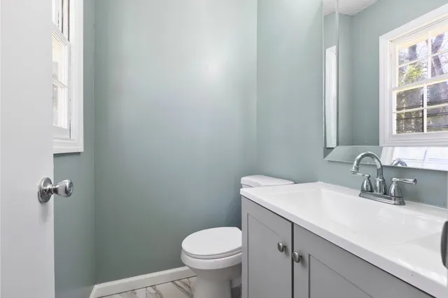 a bathroom with a sink toilet and a mirror