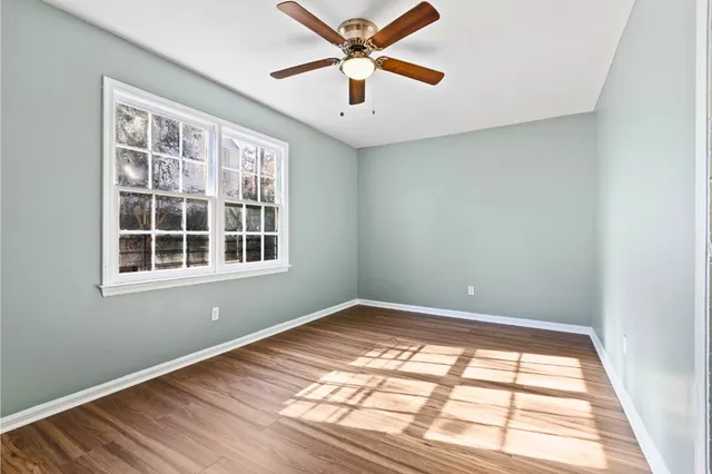wooden floor in an empty room with a window