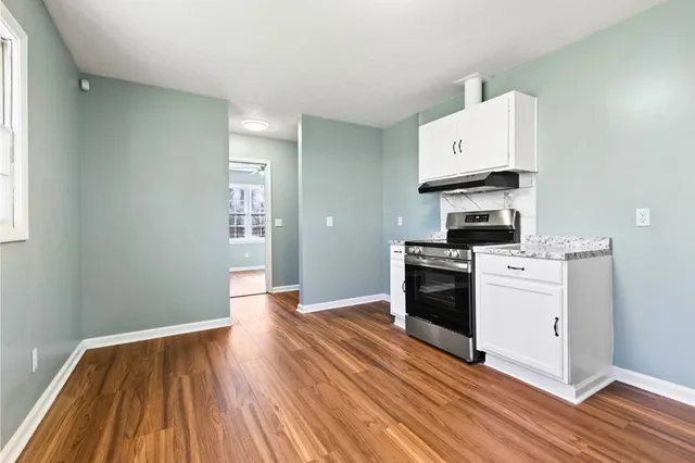 a kitchen with wooden floors and white appliances