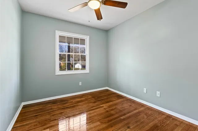 a view of a bedroom with wooden floor