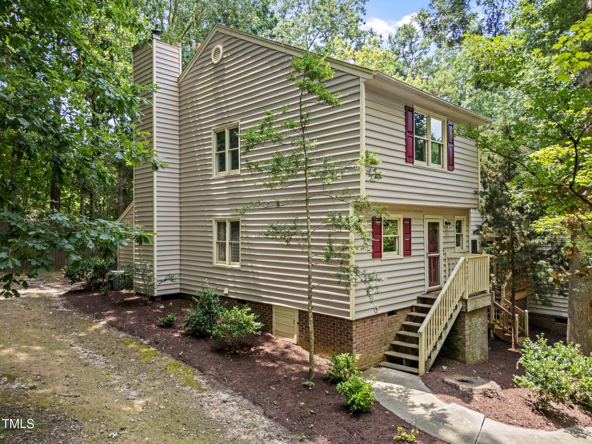a front view of a house with plants