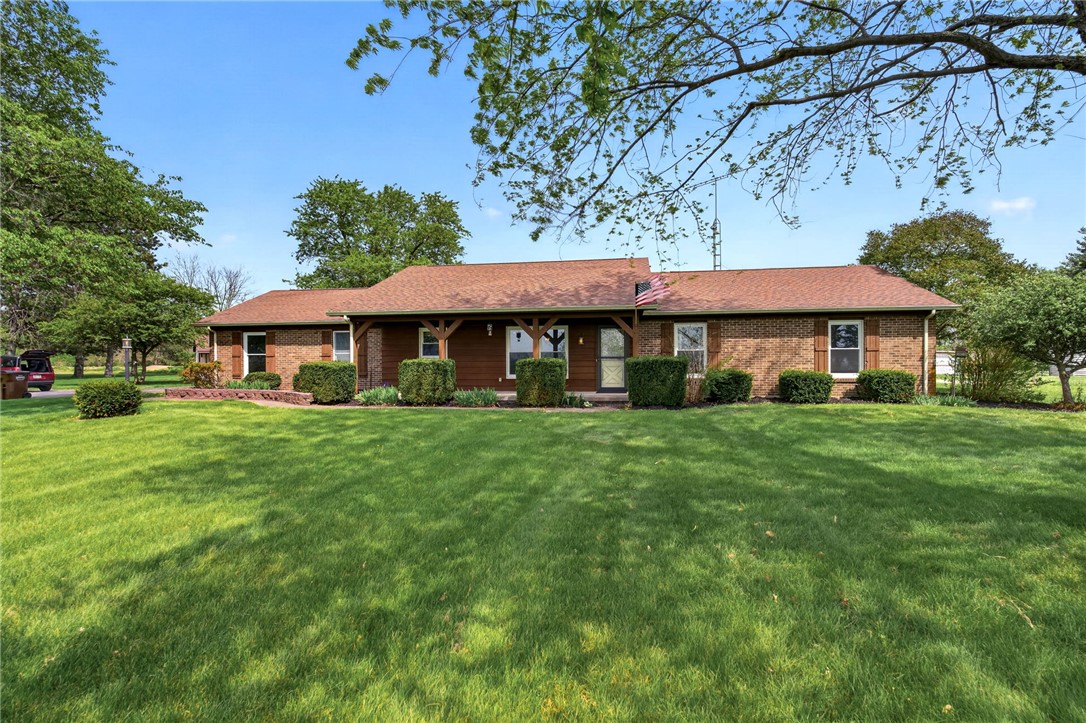 7988 McCool Road Greenville, OH 45331 - Photo 2 of 50 This charming residence features a classic brick and wood exterior, set amidst a verdant landscape.